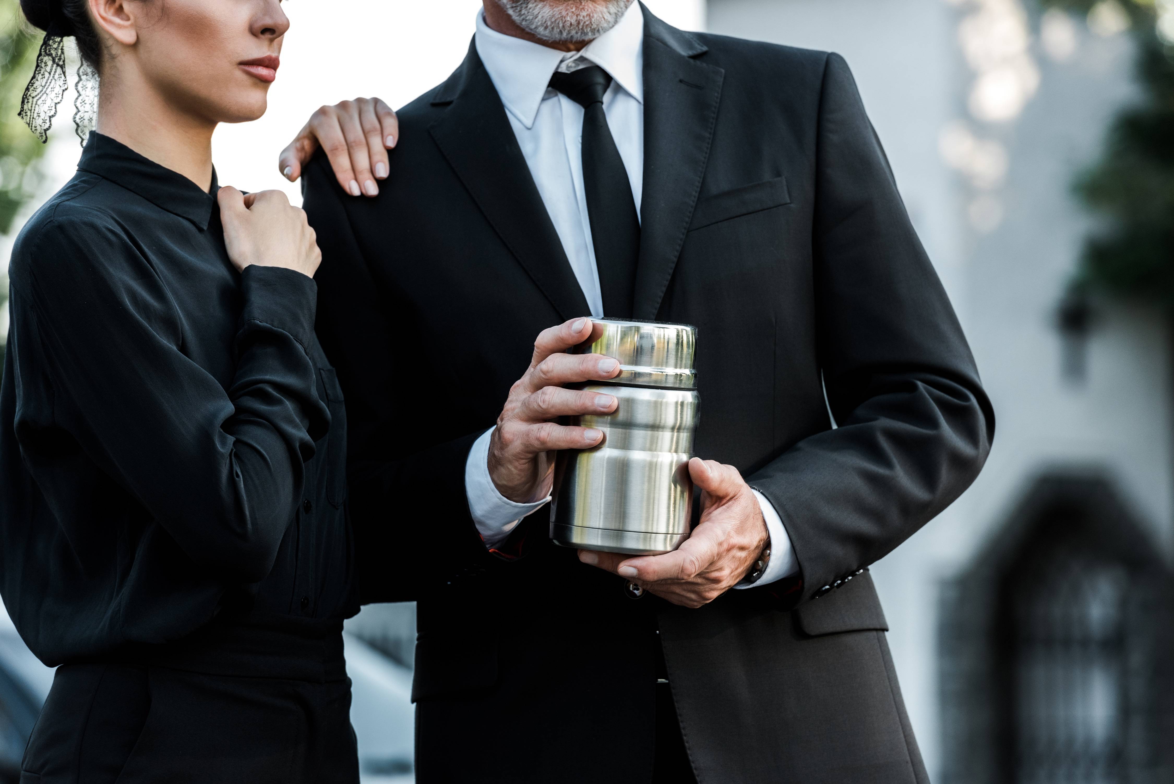 Couple holding urn