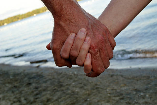 Couple holding hands on beach