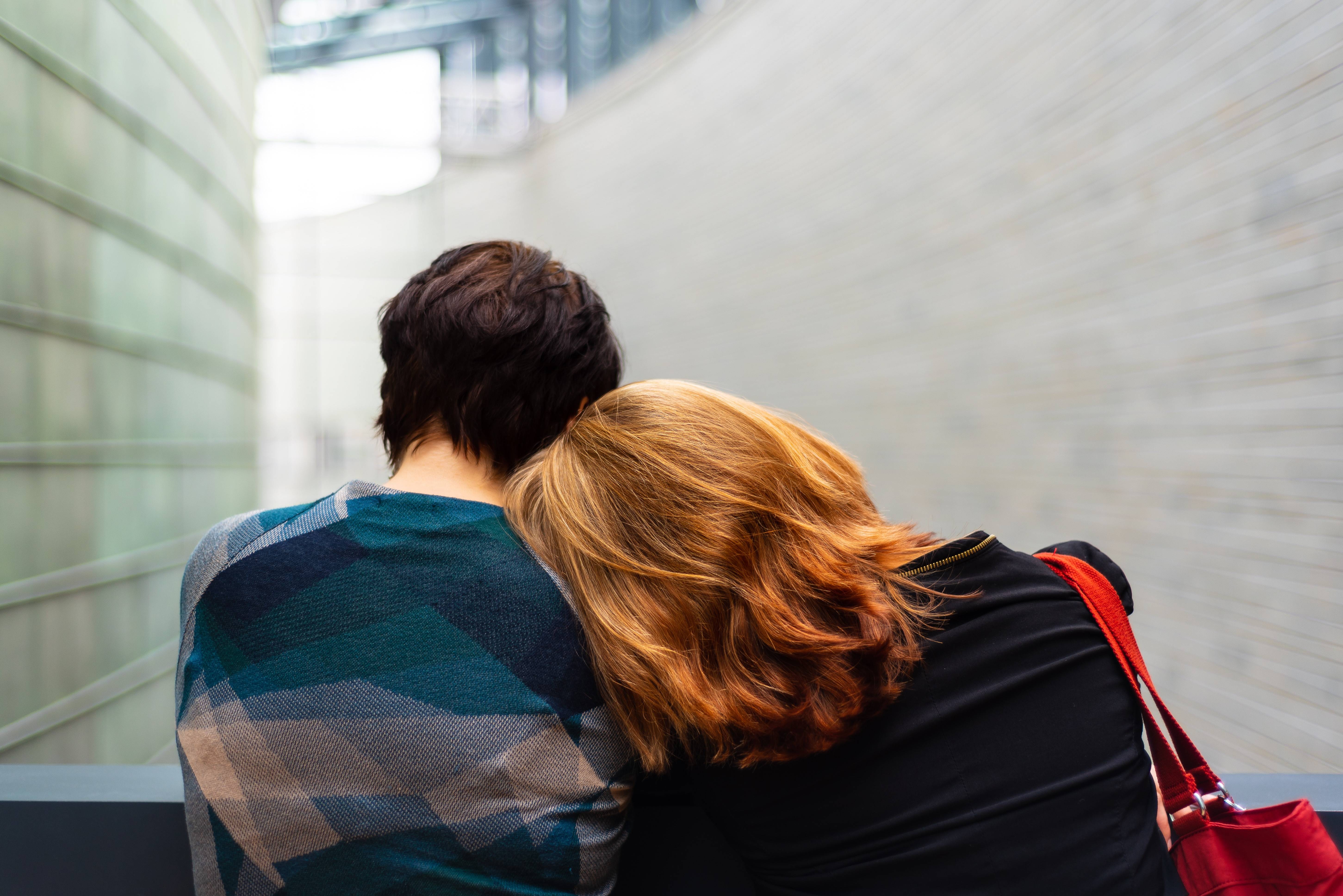 Friend leaning on another's shoulder