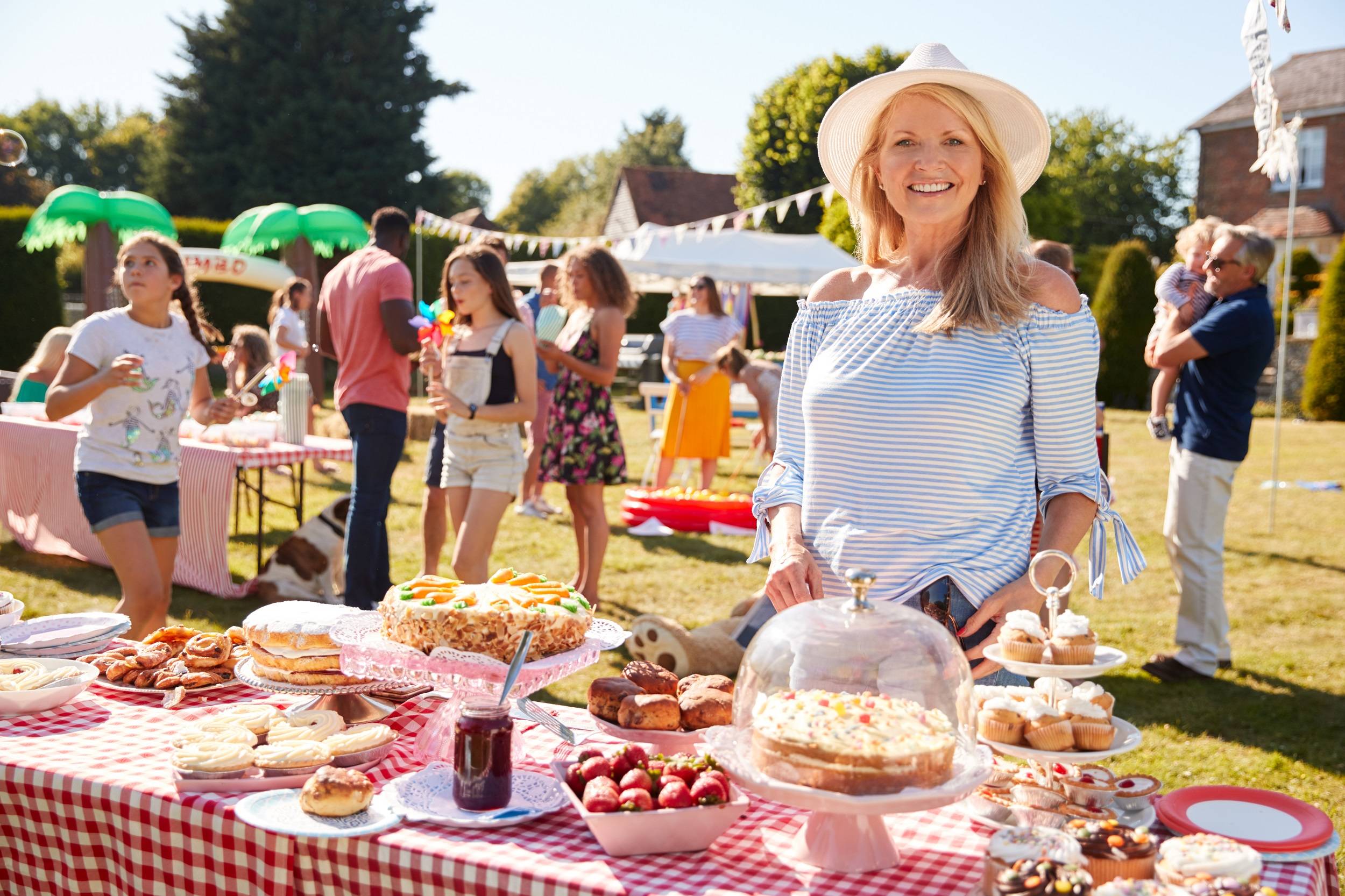 Older woman fundraising at a bake sale for charity