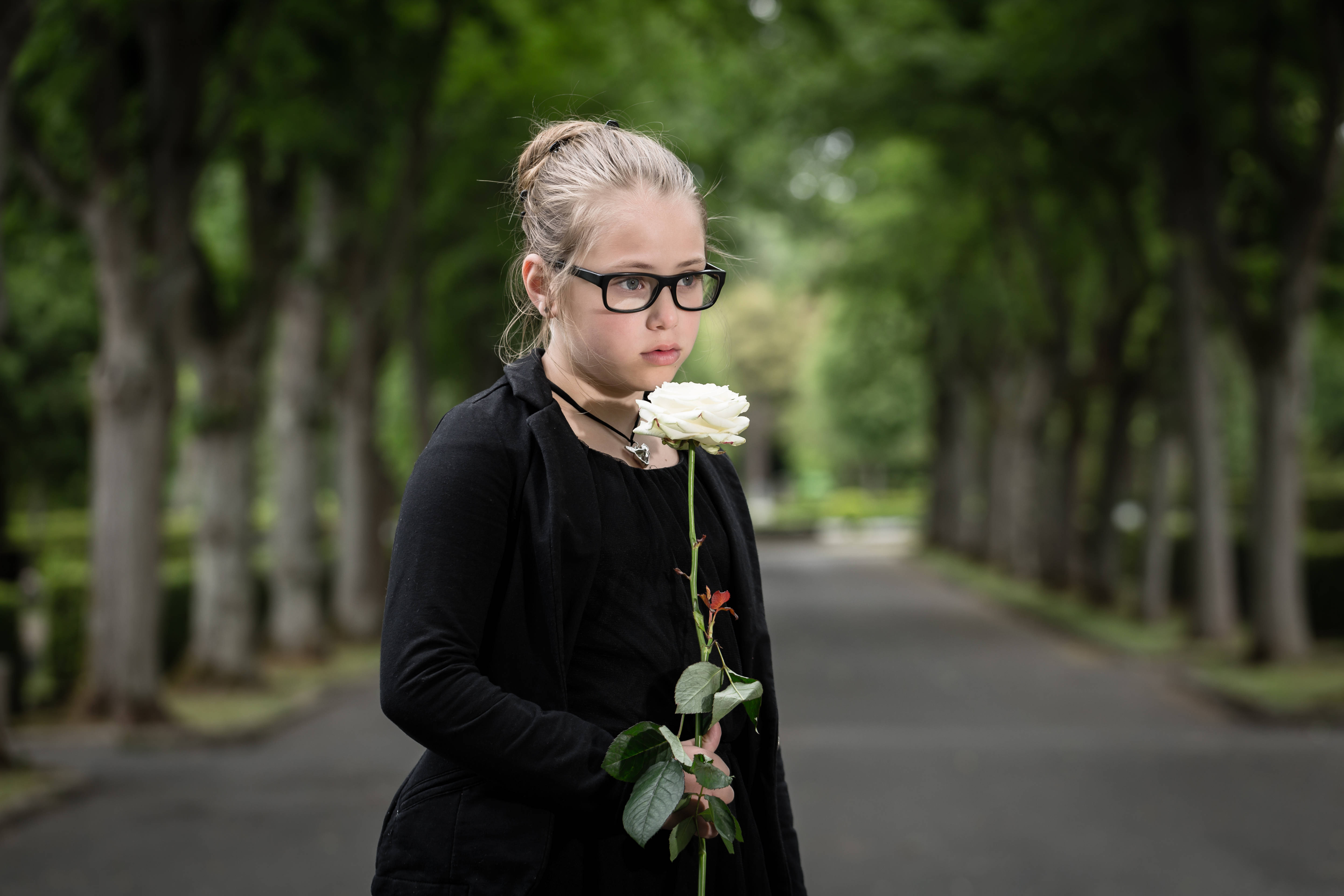 Child wearing black at a funeral