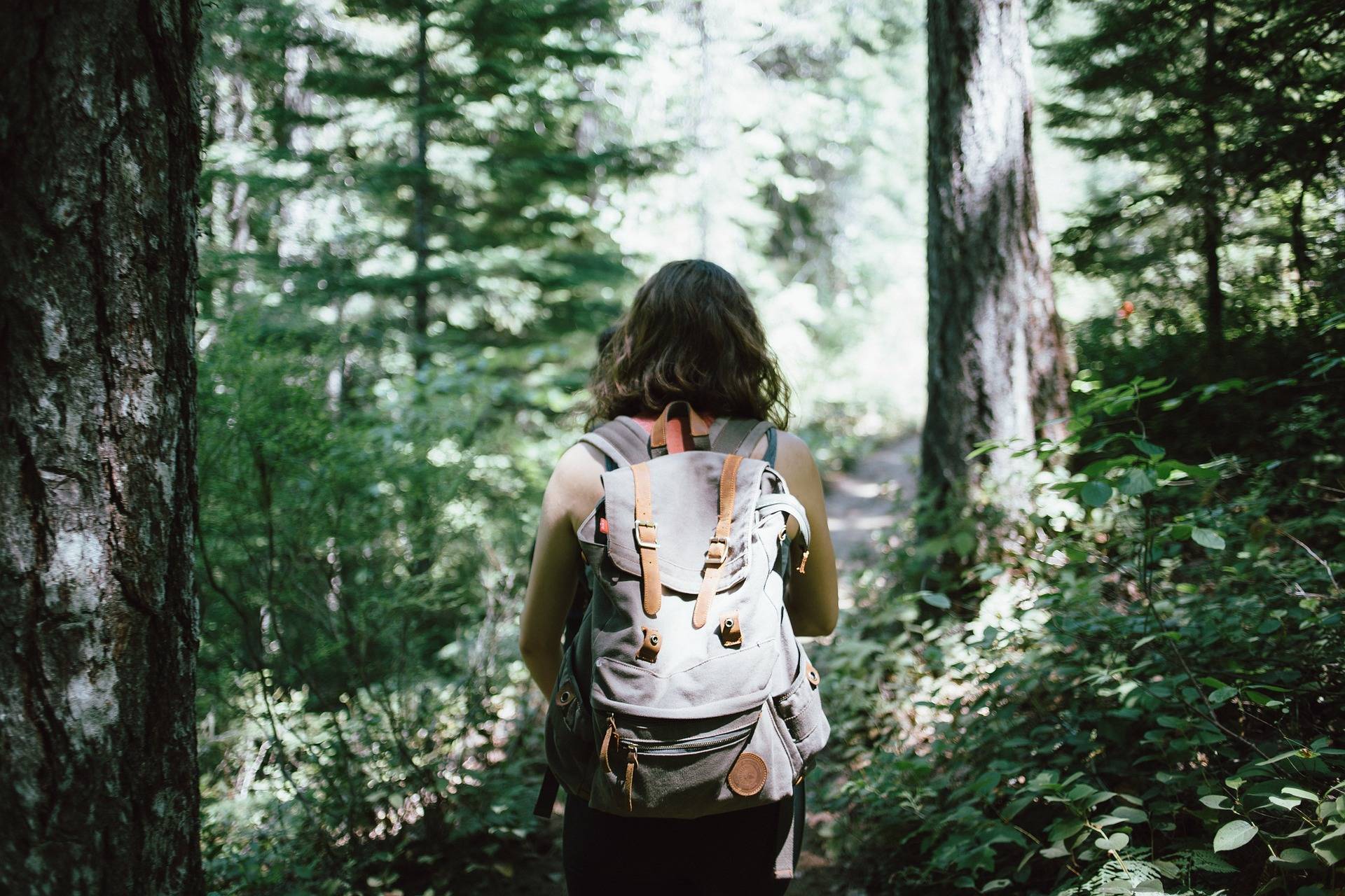 woman hiking through forest