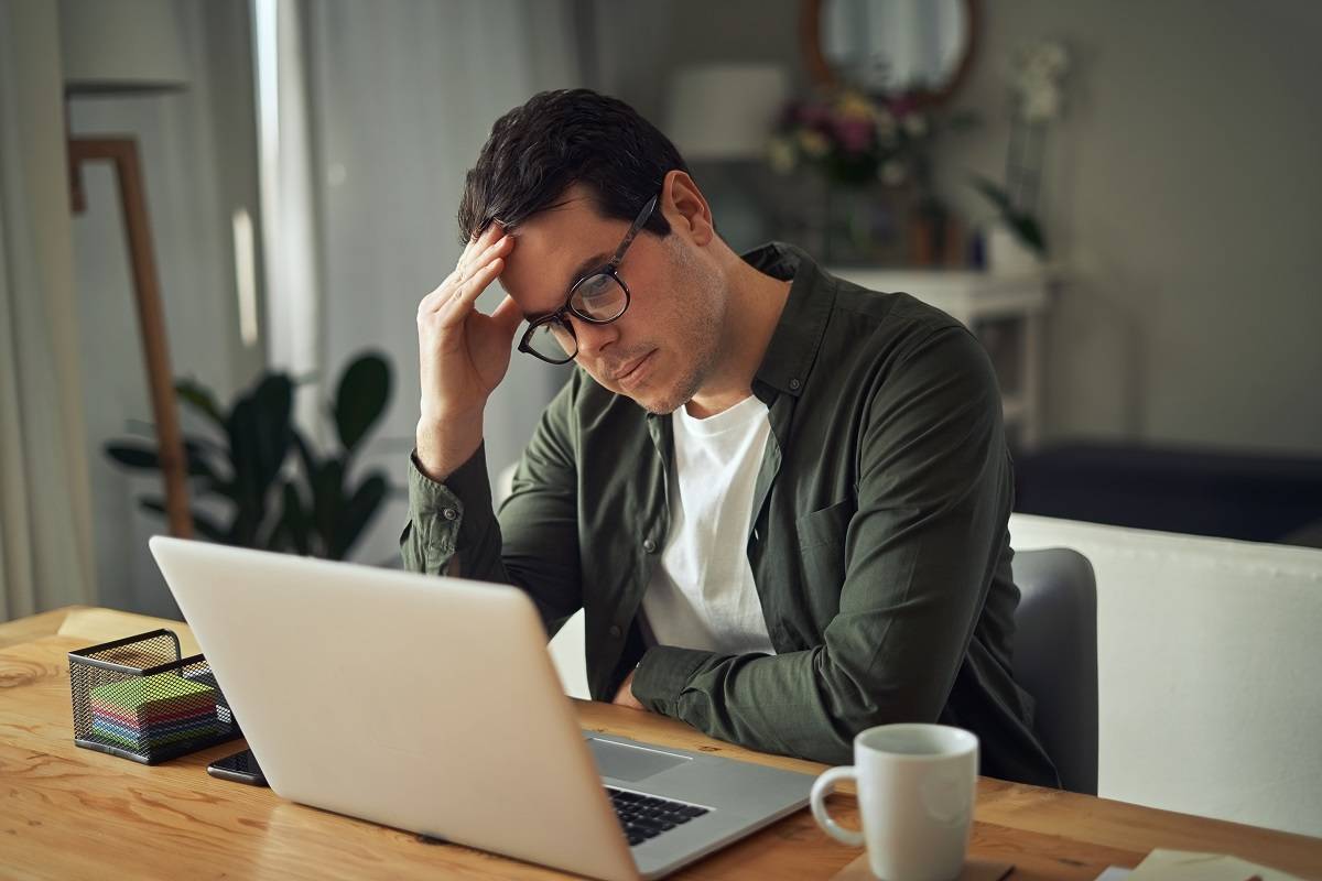 Upset man on laptop