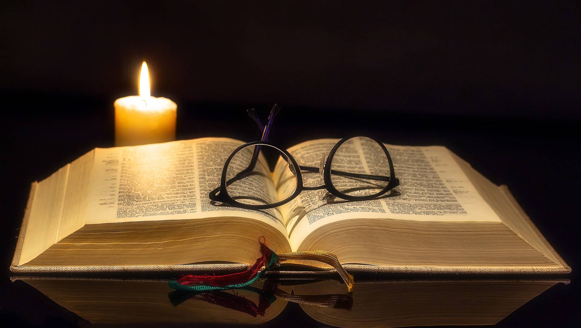 Open bible in candlelight