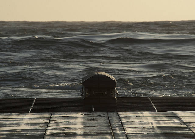 Coffin being buried at sea