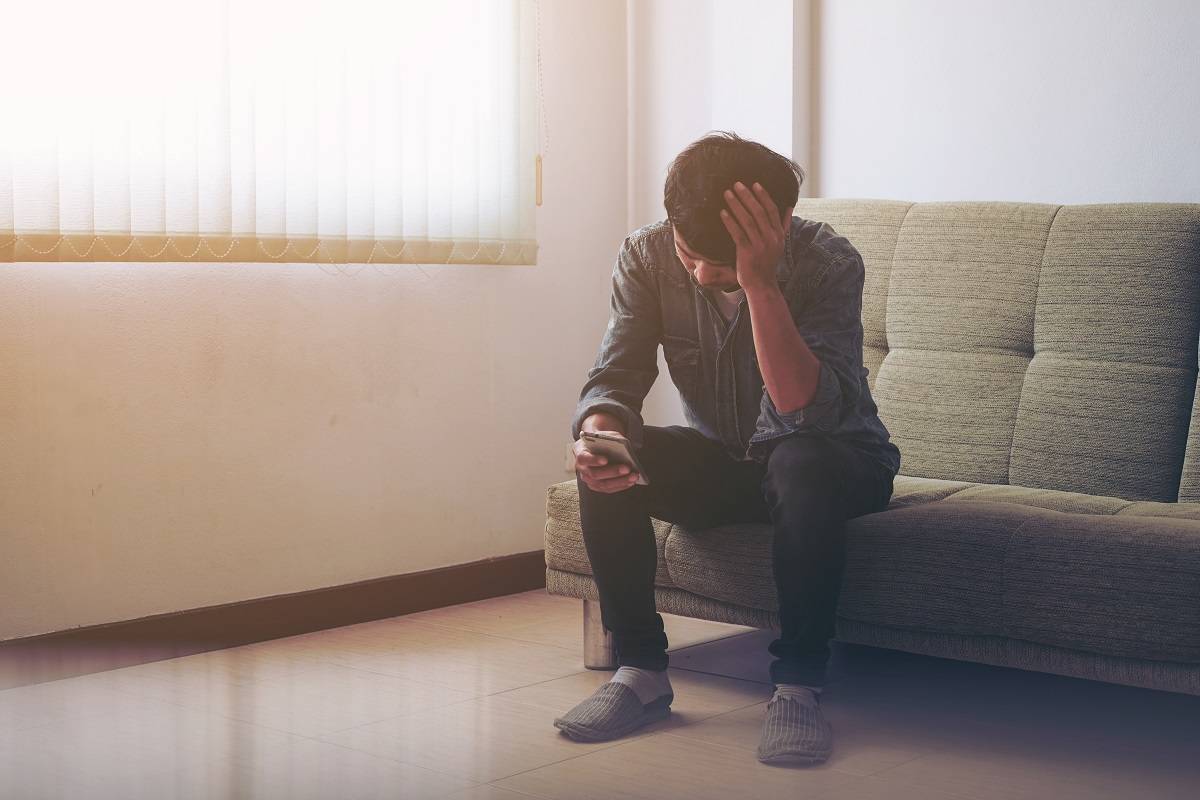 Man in grief making a phone call