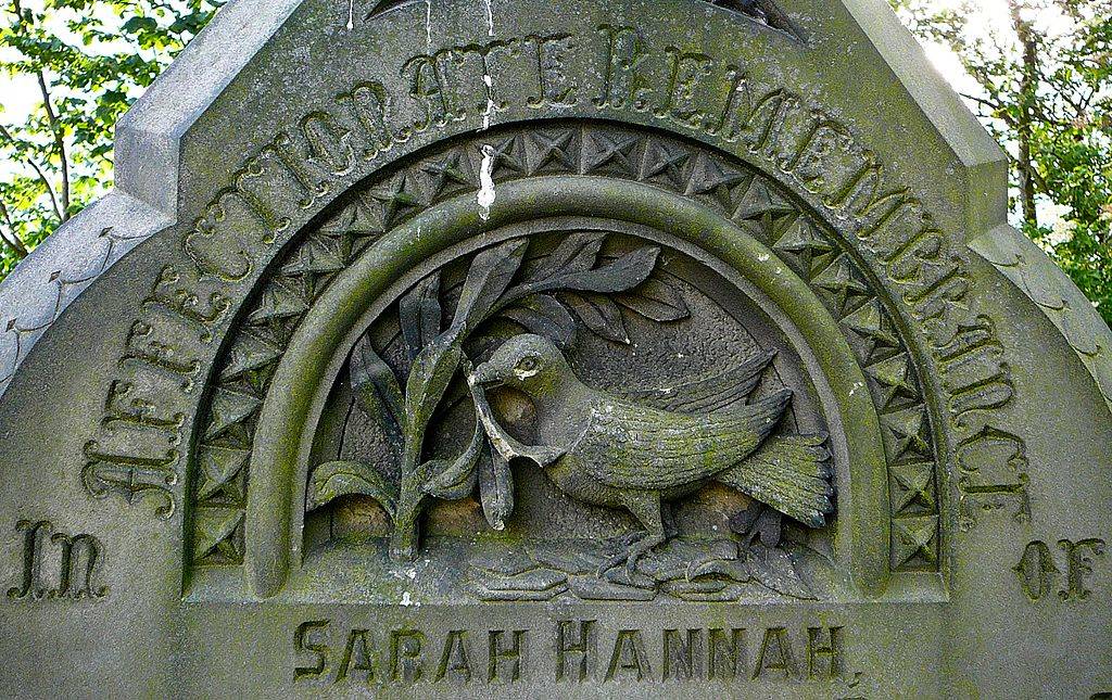 carved bird on headstone