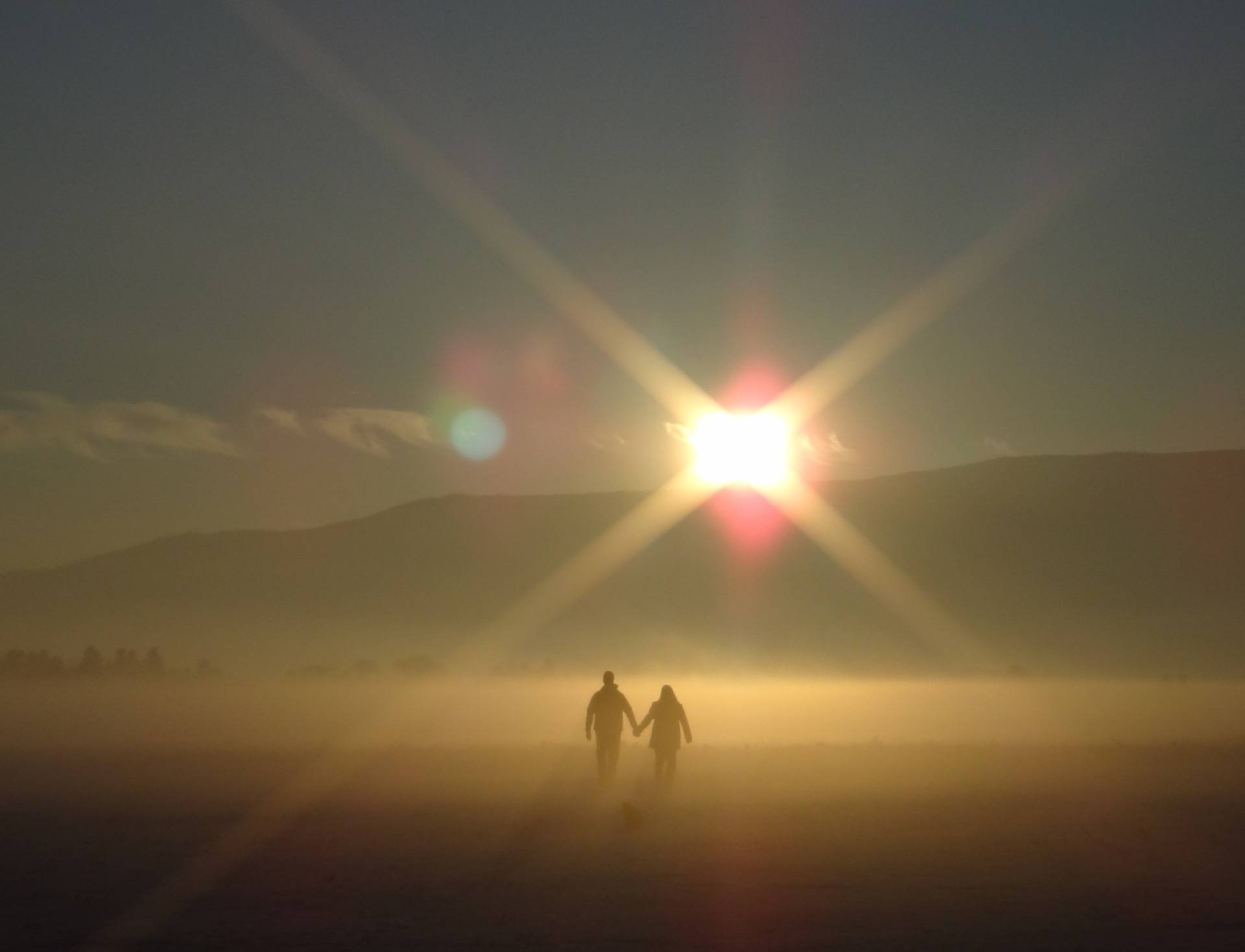two people walking through fog