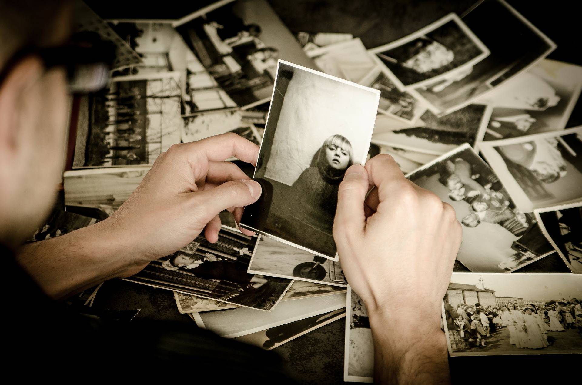 Person looking at black and white photographs