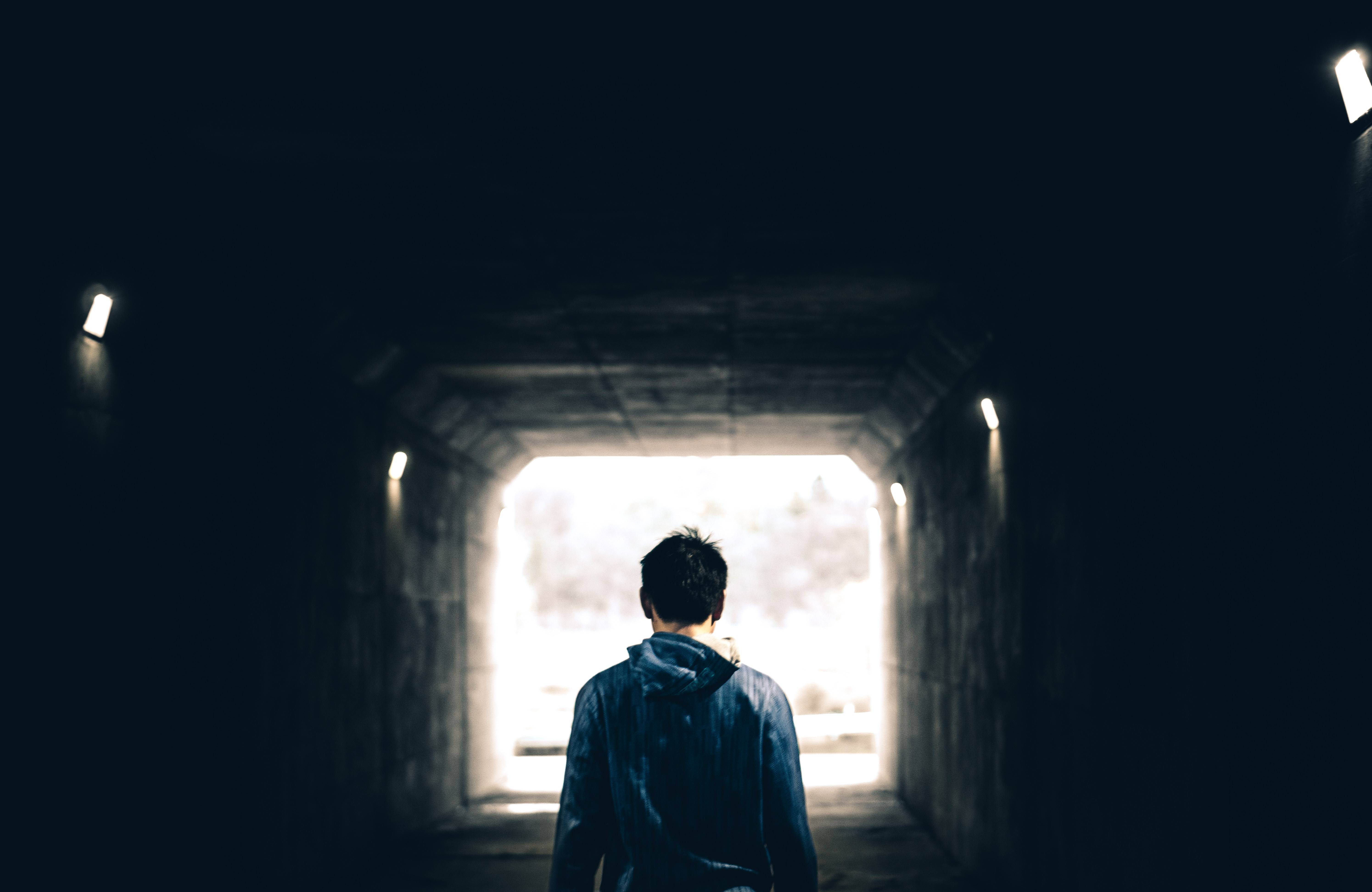 Teenage boy walking through a tunnel