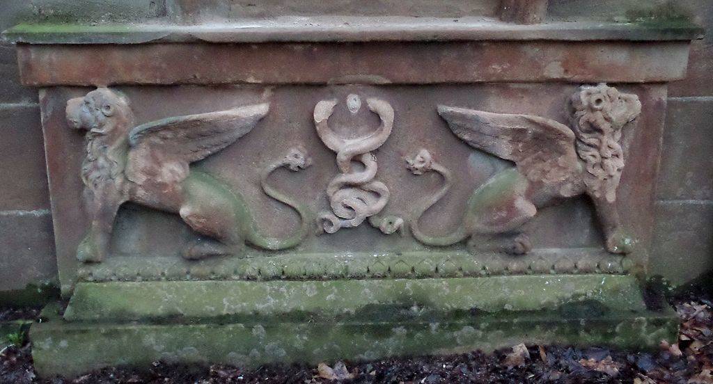 carved winged lions on headstone