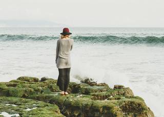 Woman standing next to the sea