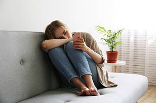 grieving woman on a sofa